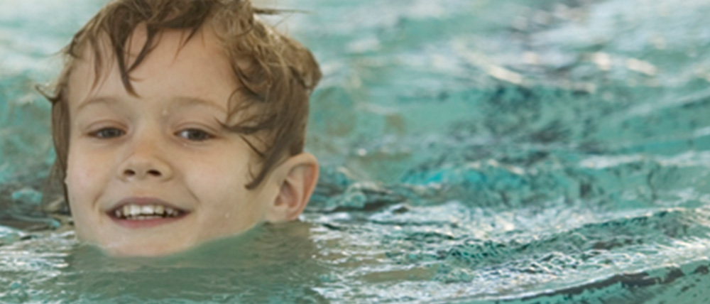 a child smiling in water