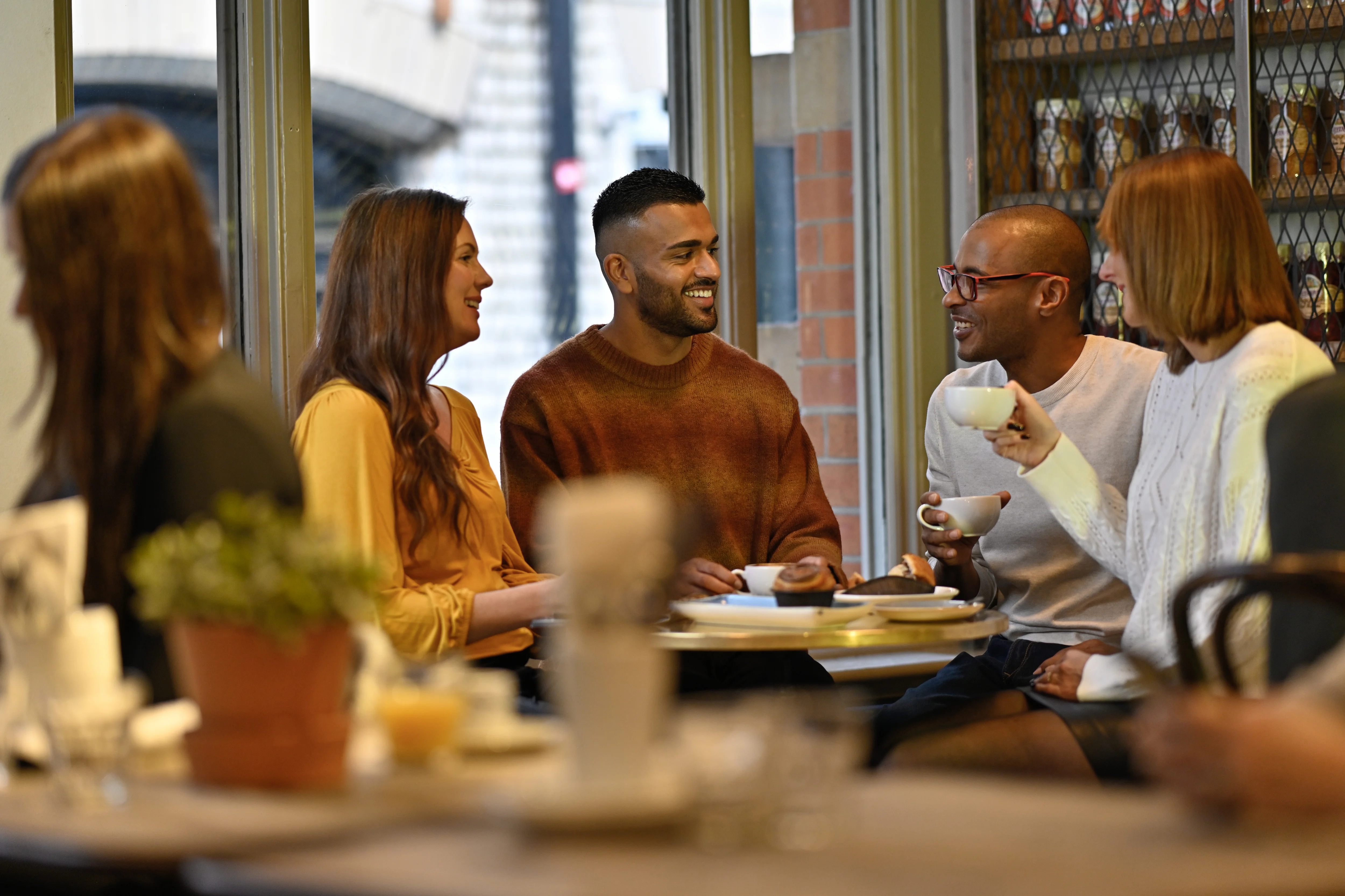 a group of people sitting at a table eating food