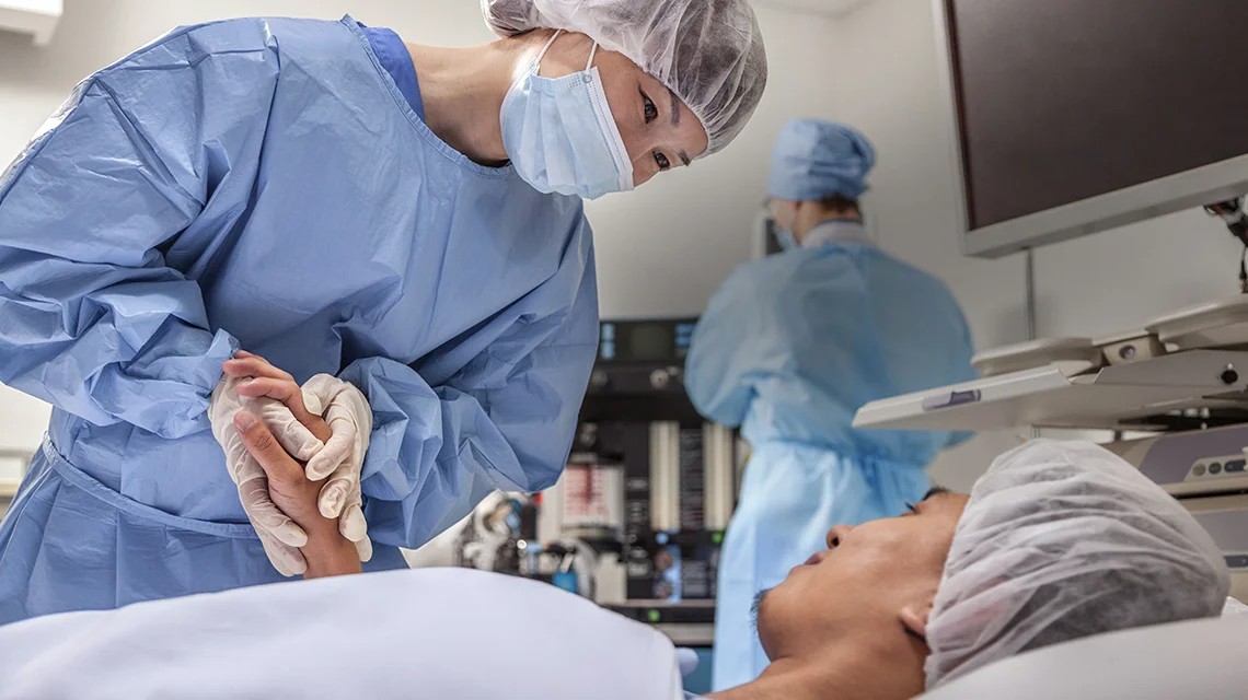 a surgeon talking to a patient about to undergo surgery