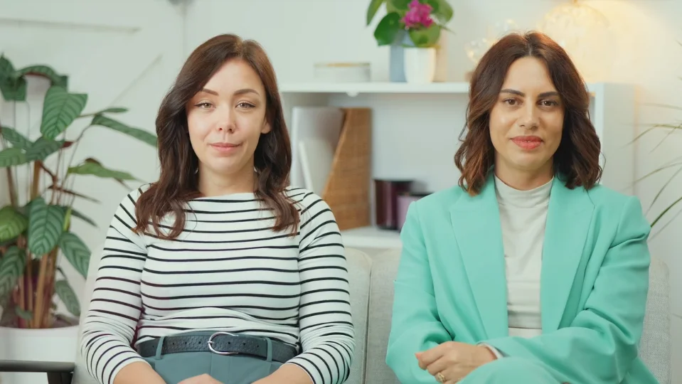 a couple of women sitting on a couch