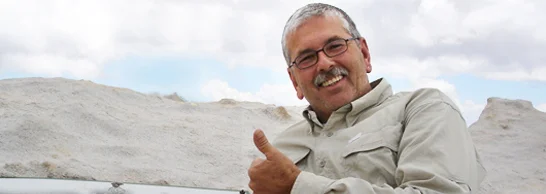 a man smiling and pointing