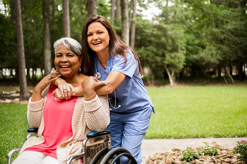 Nurse hugging patient in a wheelchair